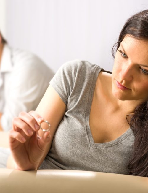 Sad wife looking at her ring after fight with husband